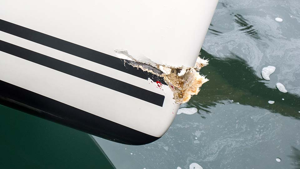 Damaged boat floating on the water.