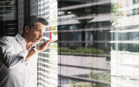 man looking outside the window.
